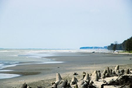 A sandy beach with lots of sand and water